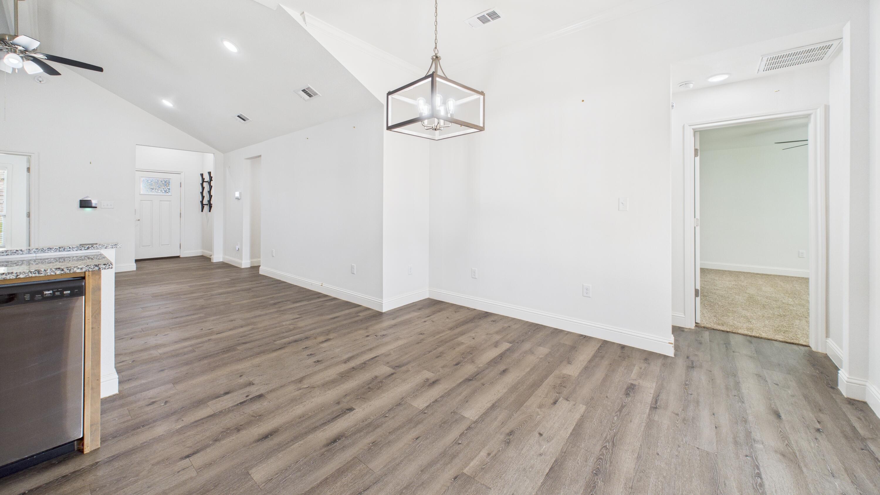 7107 23rd Street Lubbock, TX 79407 - Photo 17 of 49 a view of a room with wooden floor and staircase