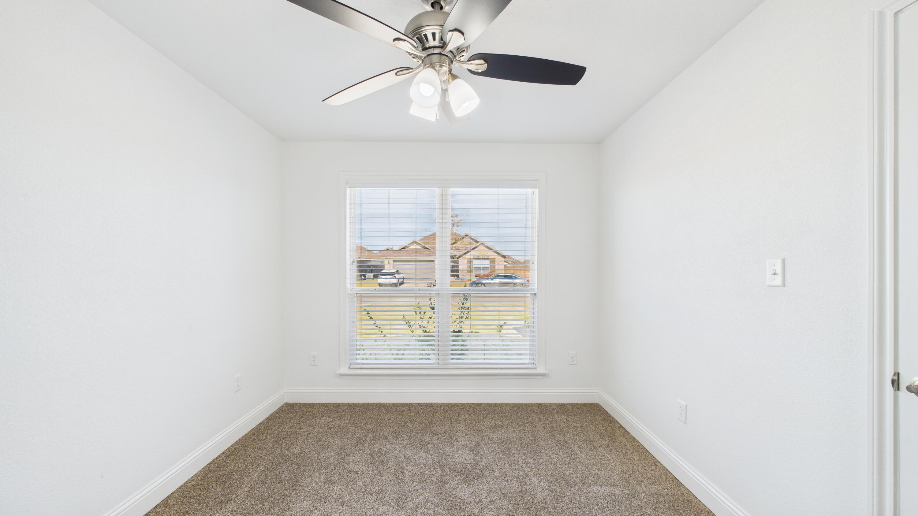 7107 23rd Street Lubbock, TX 79407 - Photo 25 of 49 an empty room with windows and fan