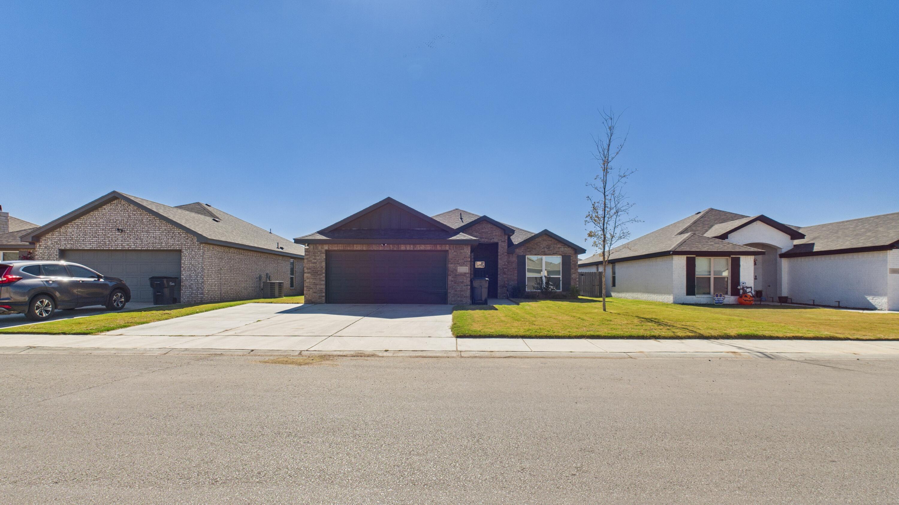7107 23rd Street Lubbock, TX 79407 - Photo 4 of 49 a front view of a house with a yard