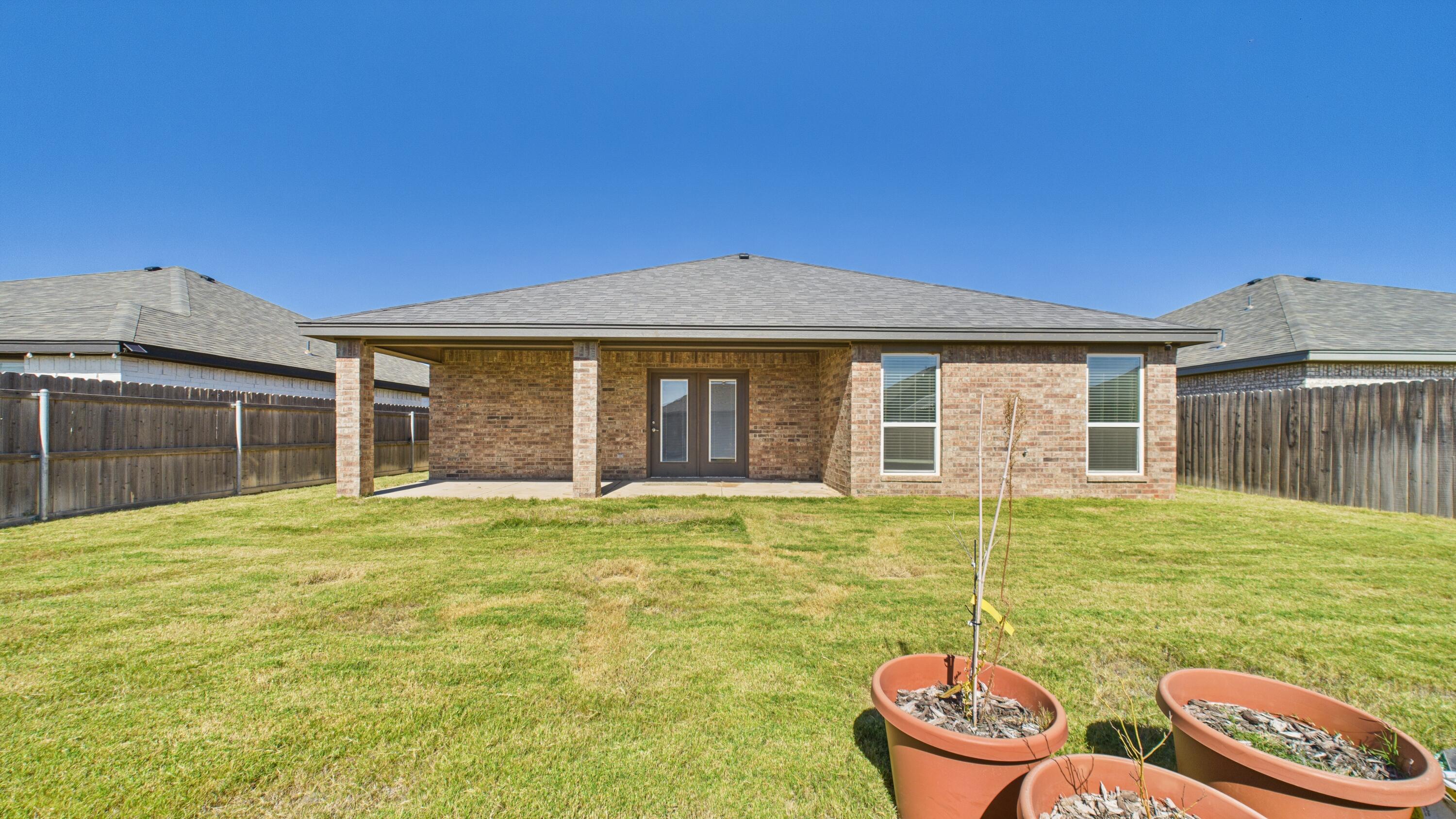 7107 23rd Street Lubbock, TX 79407 - Photo 48 of 49 a backyard of a house with yard table and chairs