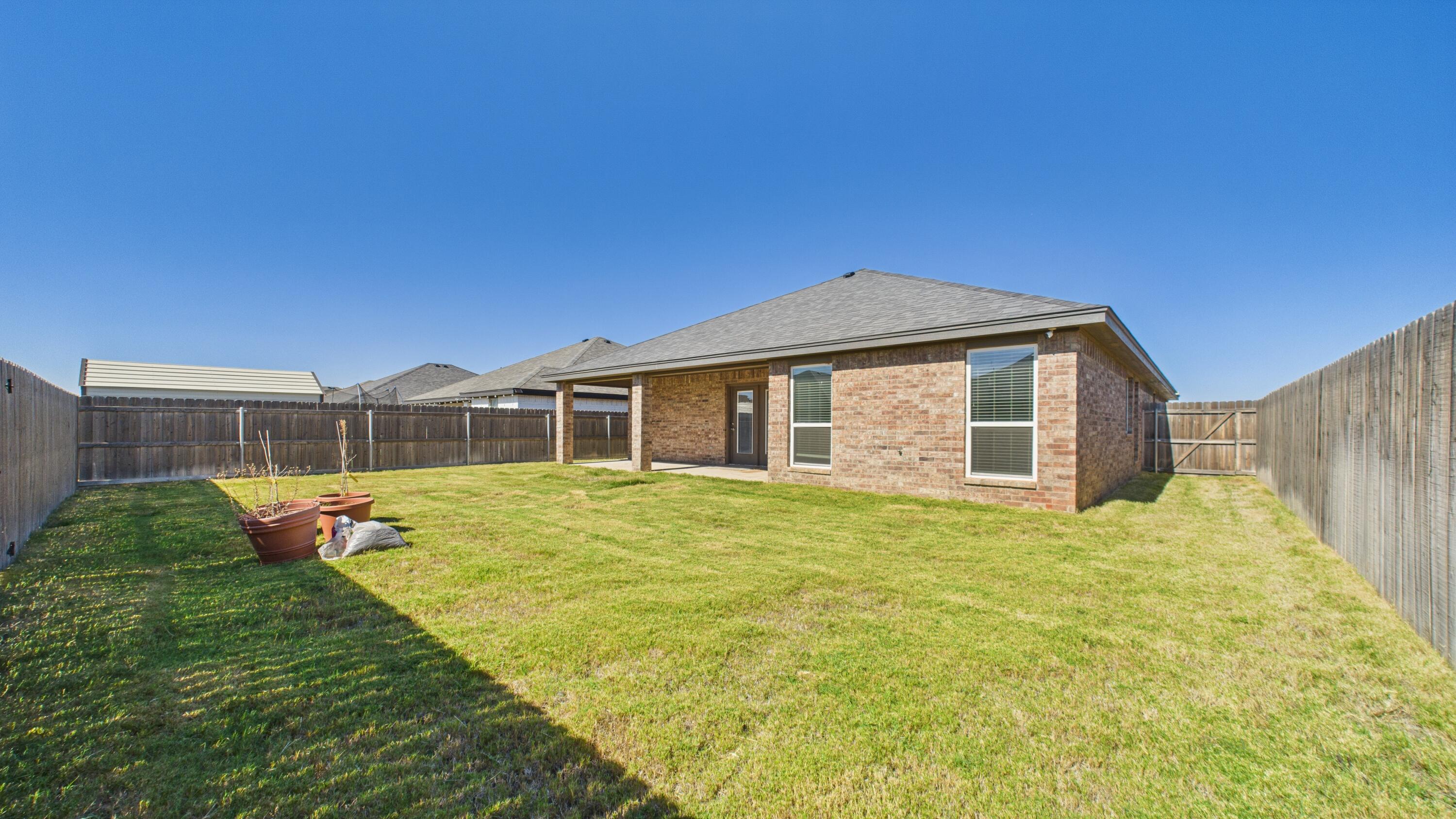 7107 23rd Street Lubbock, TX 79407 - Photo 49 of 49 a backyard of a house with table and chairs
