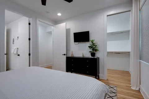 a bedroom with a bed and a flat screen tv