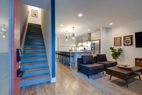 a living room with furniture and a wooden floor