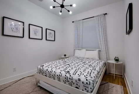 a bedroom with a bed and a chandelier