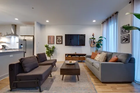 a living room with furniture and a flat screen tv