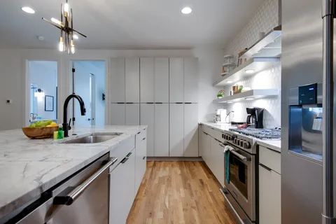 a kitchen with a sink appliances and cabinets
