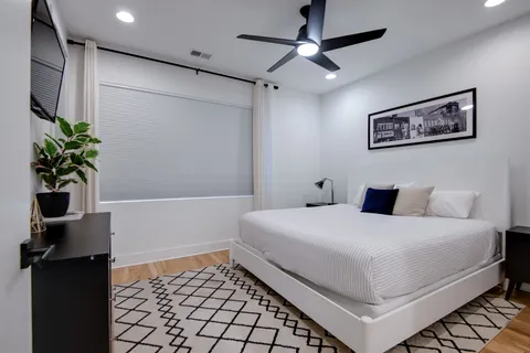 a bedroom with a bed and a potted plant