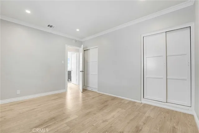 a view of a room with wooden floor and windows