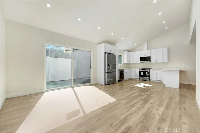 a kitchen with a sink a stove a microwave and cabinets