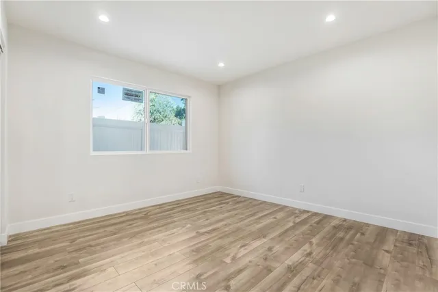 a bathroom with a toilet sink vanity and mirror