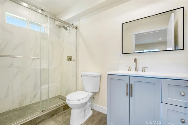 an empty room with wooden floor and window