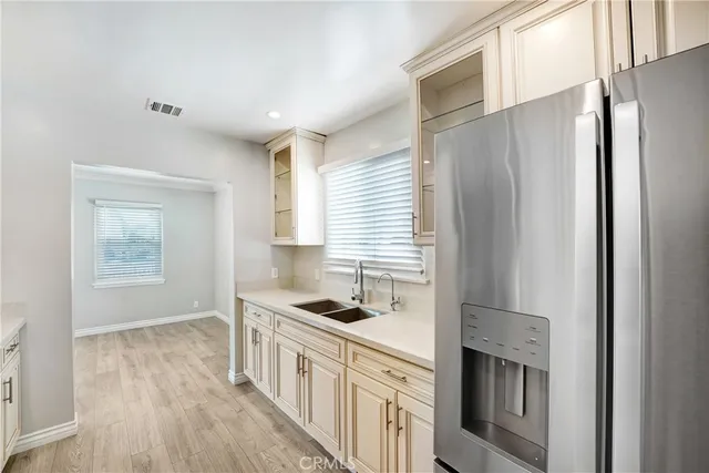 a kitchen with stainless steel appliances a stove sink microwave and refrigerator