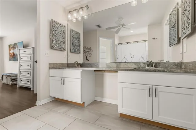 a bathroom with a sink vanity and mirror