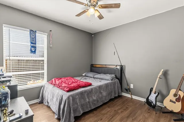 a bedroom with a bed and wooden floor