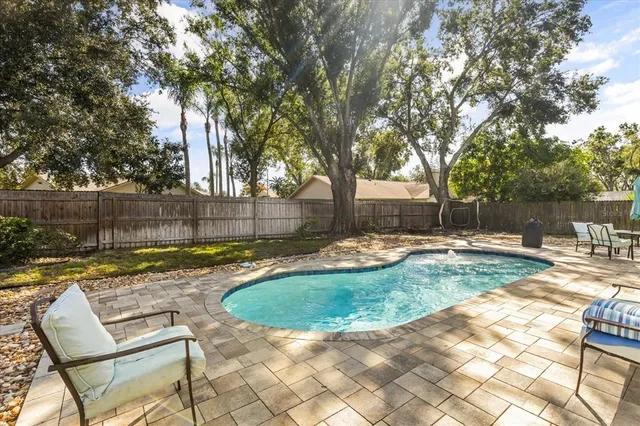 a view of backyard with swimming pool