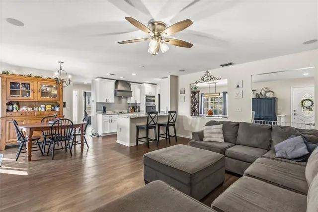 a living room with furniture kitchen view and a dining table