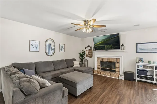 a living room with furniture flat screen tv and a fireplace
