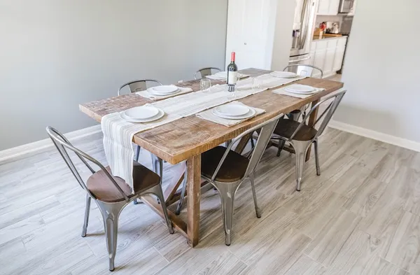 a view of a dining room with furniture and wooden floor