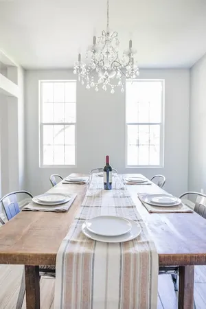 a dining table with a chandelier