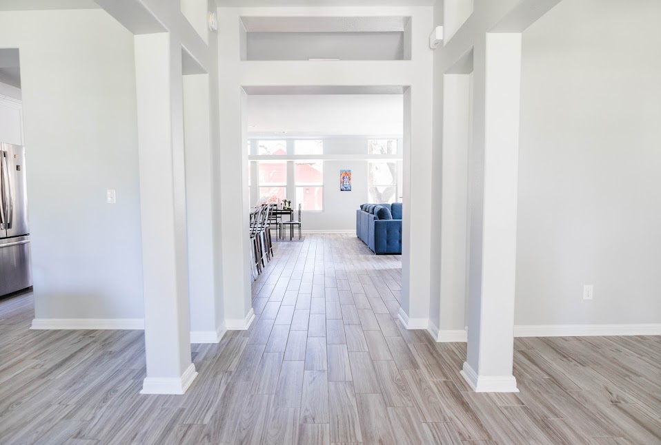 411 Wetzel Kyle, TX 78640 - Photo 16 of 28 a view of a hallway with wooden floor and furniture