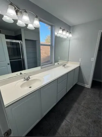 a bathroom with a double vanity sink and a mirror