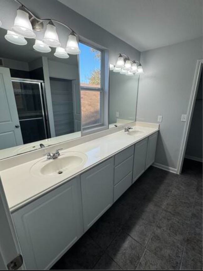 411 Wetzel Kyle, TX 78640 - Photo 21 of 28 a bathroom with a double vanity sink and a mirror