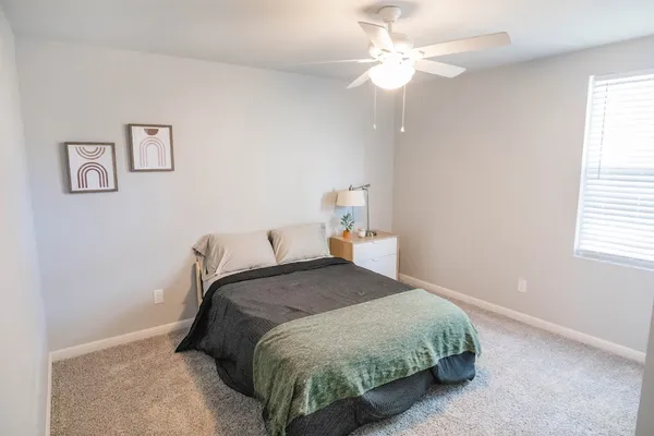 a bedroom with a bed and a chandelier