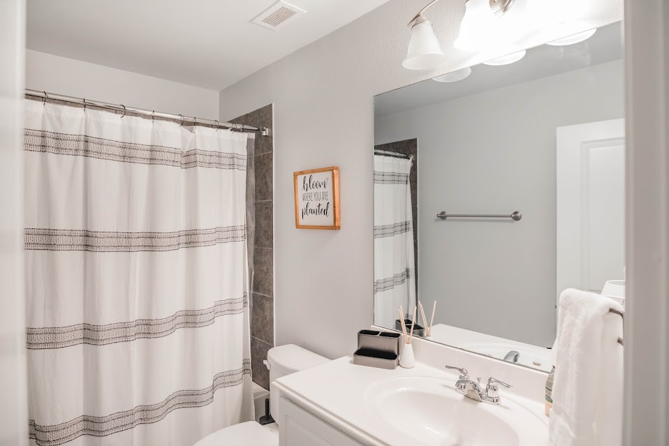 411 Wetzel Kyle, TX 78640 - Photo 27 of 28 a bathroom with a sink and a mirror