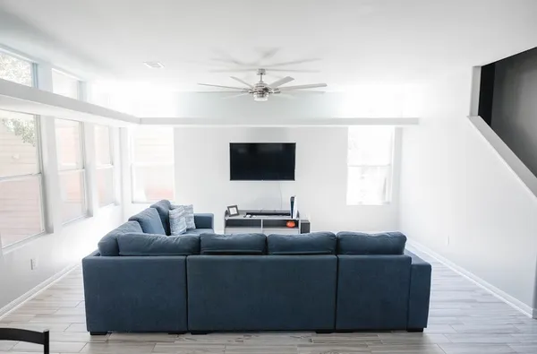 a living room with furniture and a flat screen tv