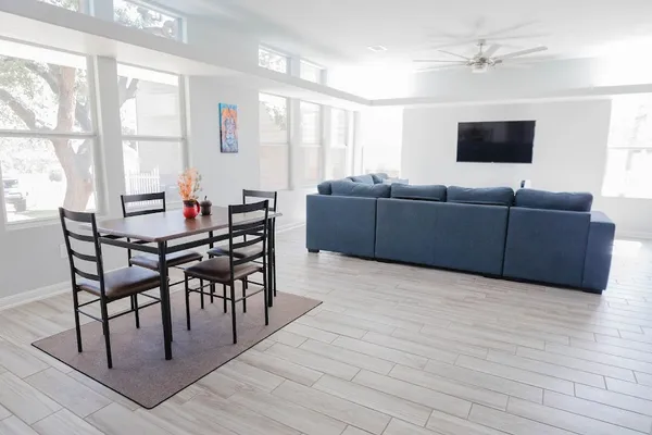 a living room with furniture a flat screen tv and a window