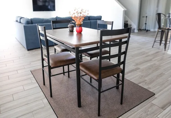 a dining room with furniture and wooden floor