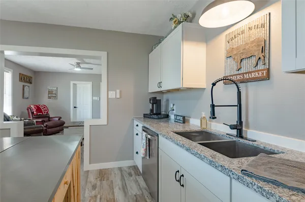 a kitchen with a sink and a stove top oven