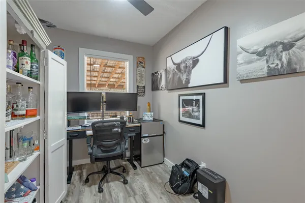 a view of a workspace with furniture and a window