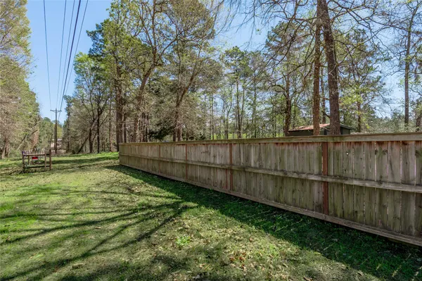 a view of a backyard with wooden fence