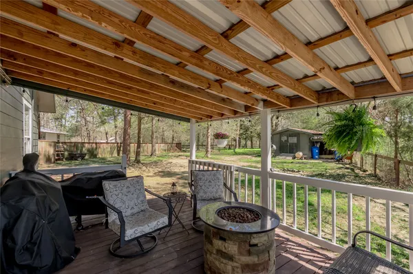 a view of a porch with furniture and a backyard