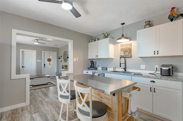 a kitchen with a sink appliances and cabinets