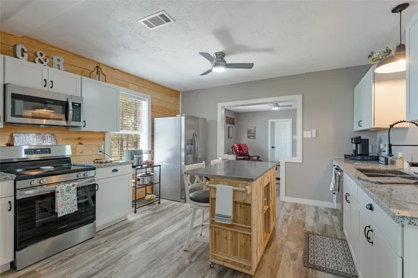 a kitchen with a stove a sink and a refrigerator