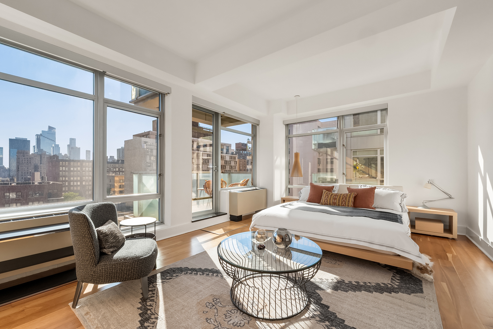 426 West 58th Street, Unit PH3 Manhattan, NY 10019 - Photo 12 of 22 a living room with furniture and a large window