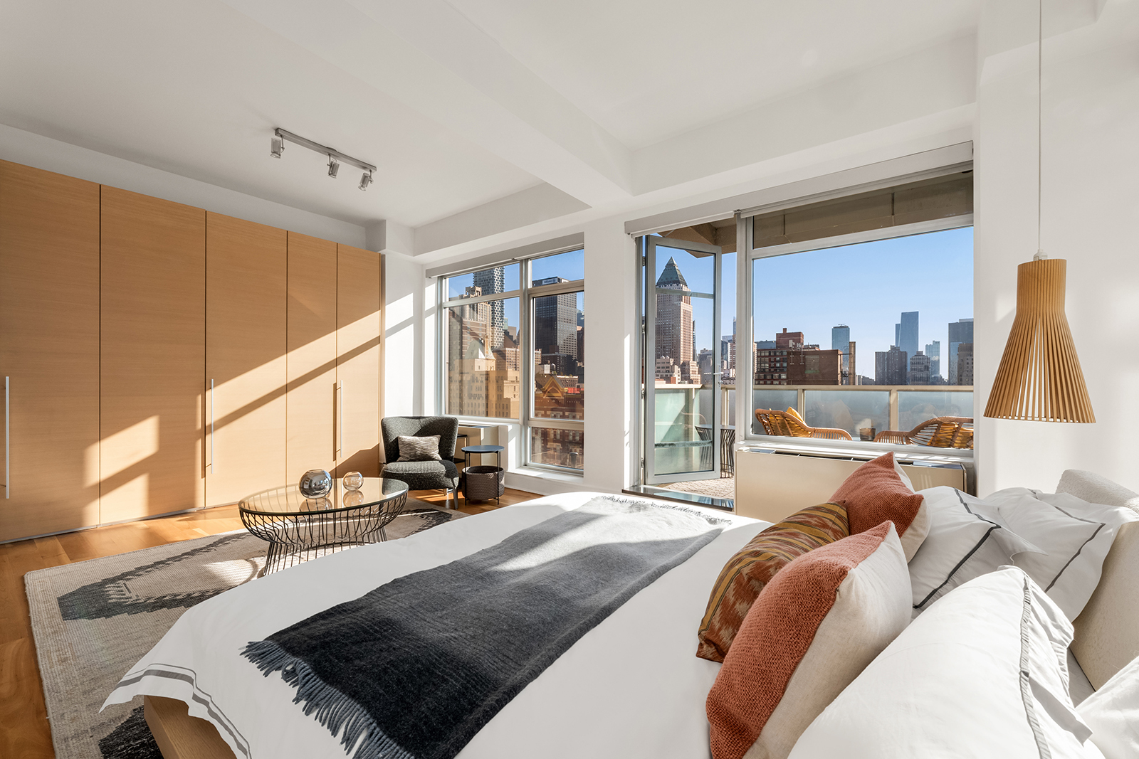 426 West 58th Street, Unit PH3 Manhattan, NY 10019 - Photo 13 of 22 a bed room with a bed and a large window