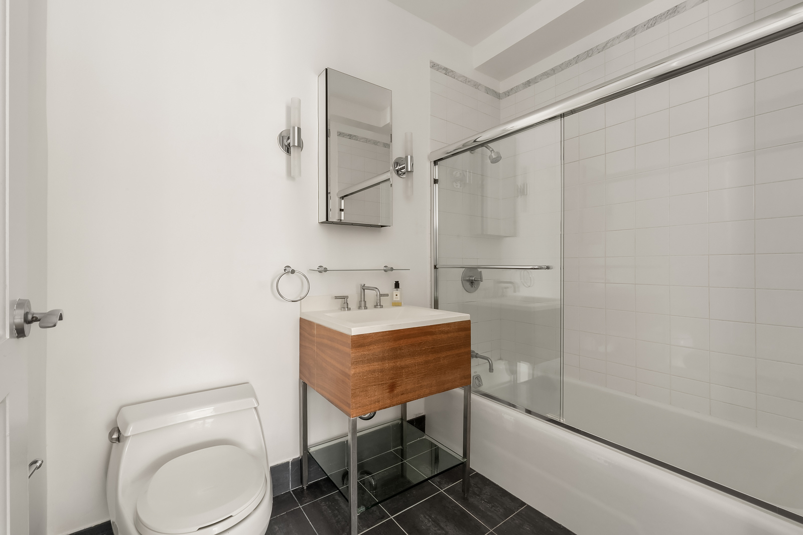 426 West 58th Street, Unit PH3 Manhattan, NY 10019 - Photo 17 of 22 a bathroom with a sink toilet and shower