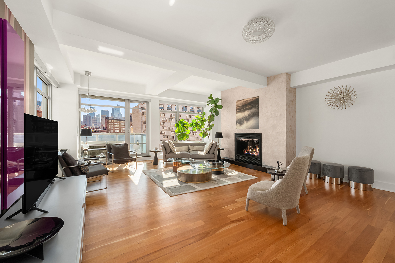 426 West 58th Street, Unit PH3 Manhattan, NY 10019 - Photo 2 of 22 a living room with fireplace furniture and a wooden floor