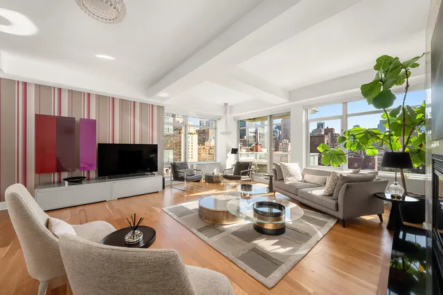 a living room with fireplace furniture and a wooden floor