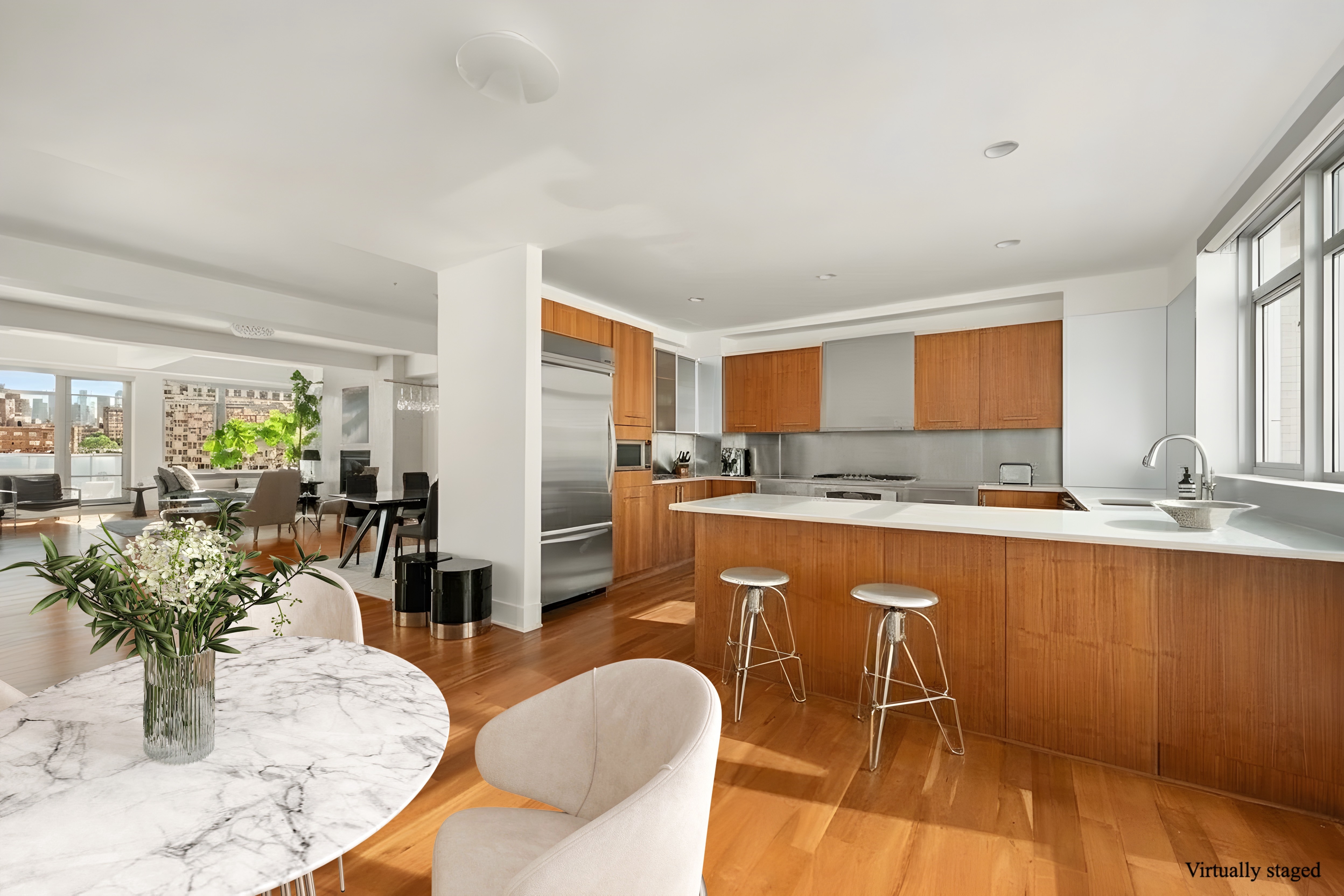 426 West 58th Street, Unit PH3 Manhattan, NY 10019 - Photo 5 of 22 a kitchen with stainless steel appliances granite countertop a sink and cabinets
