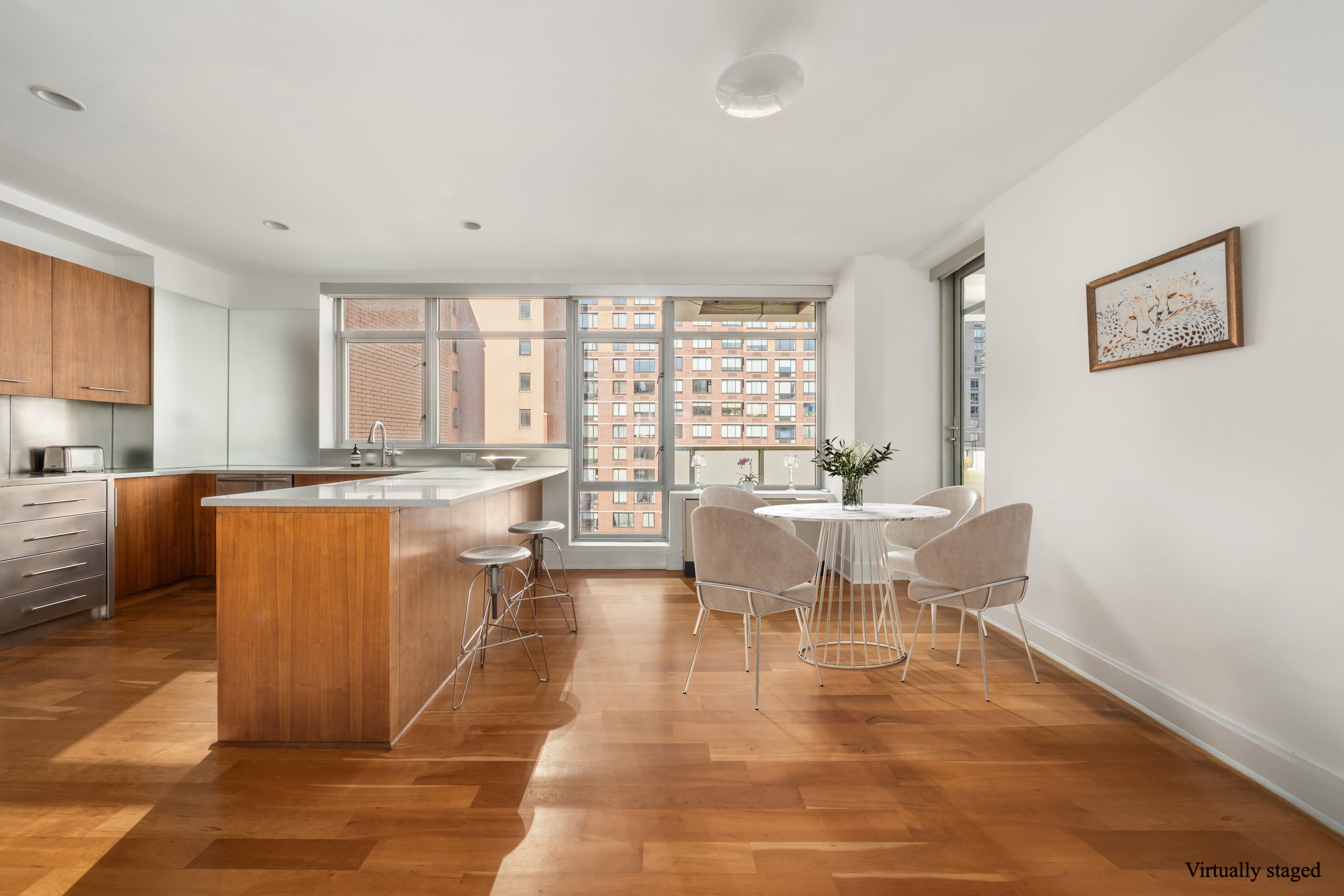 426 West 58th Street, Unit PH3 Manhattan, NY 10019 - Photo 8 of 22 a living room with kitchen island furniture and a large window