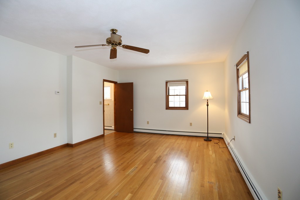 1 Beverly Road Natick, MA 01760 - Photo 16 of 22 a view of an empty room with window and wooden floor
