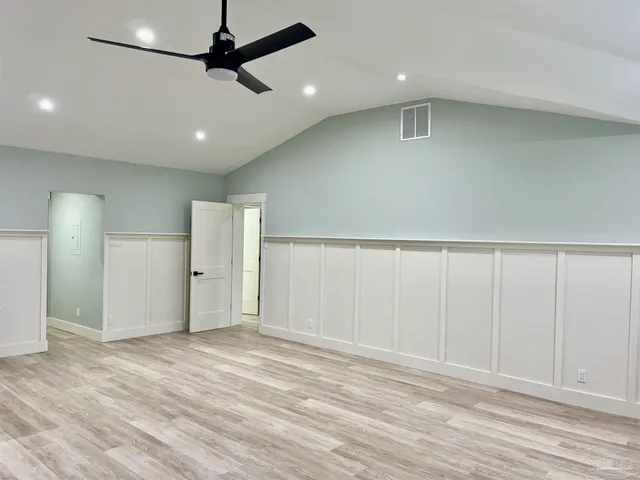 a view of a kitchen with a sink and a refrigerator