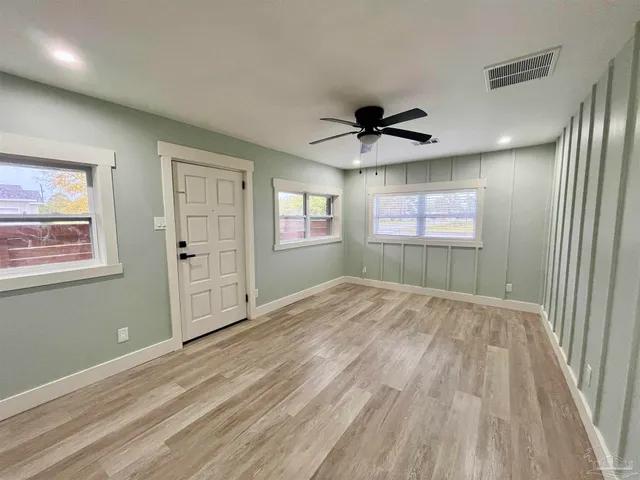 a view of a livingroom with a ceiling fan and window