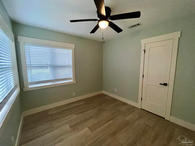 a view of room with window and ceiling fan
