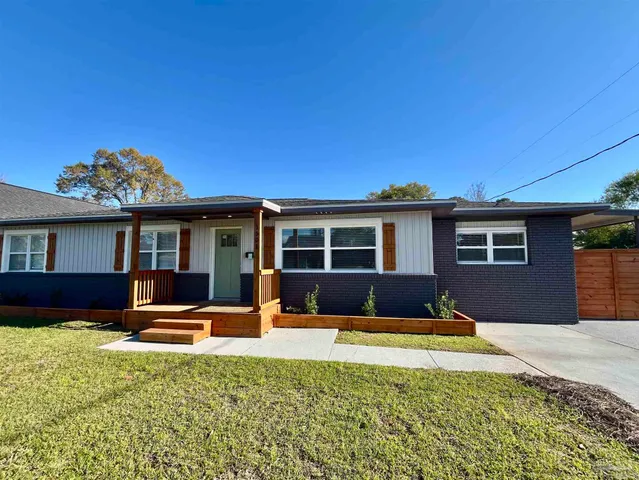 a front view of a house with a yard fire pit and outdoor seating