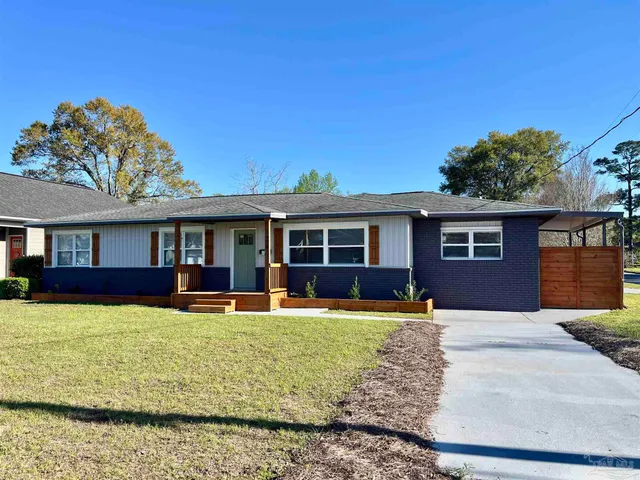 a front view of a house with a yard table and chairs